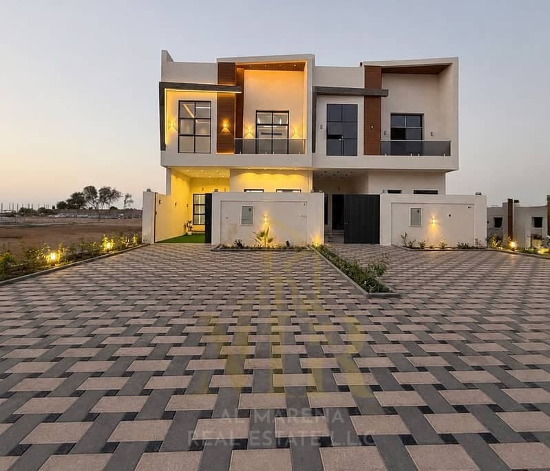Luxury villa for sale in Al Helio 2 – Ajman | Includes electricity and water | Located on a main road with an 18-meter setback | 4 master bedrooms | R, Al Helio