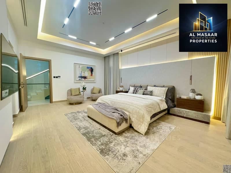 Villa for sale on Sheikh Mohammed Bin Zayed Road, located on a main street near the park. It features two floors and a rooftop terrace. Freehold owner, Al Helio